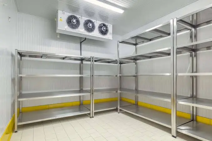 Interior of a walk-in cold room in Kenya with stainless steel shelving and ceiling-mounted evaporator